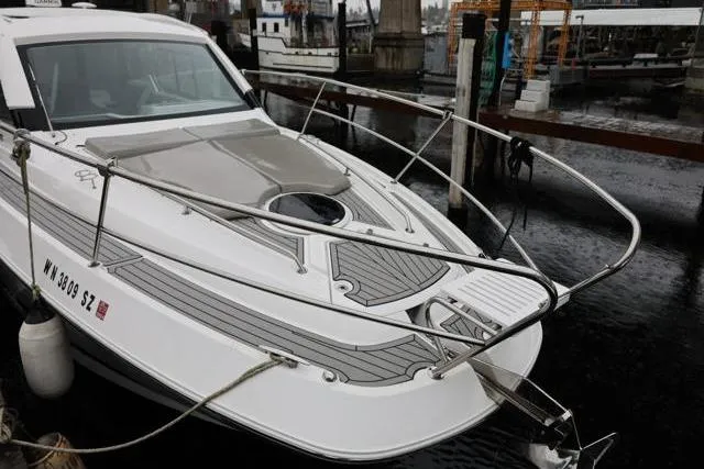  Yacht Photos Pics 2021 Four Winns V355 Coupe docked at a marina, showcasing sleek design and modern features.