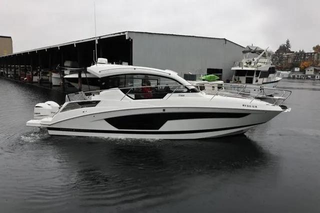  Yacht Photos Pics 2021 Four Winns V355 Coupe boat docked in a marina on a cloudy day.