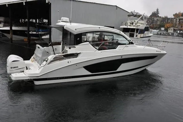  Yacht Photos Pics 2021 Four Winns V355 Coupe boat docked in a marina, featuring sleek design and Yamaha engines.