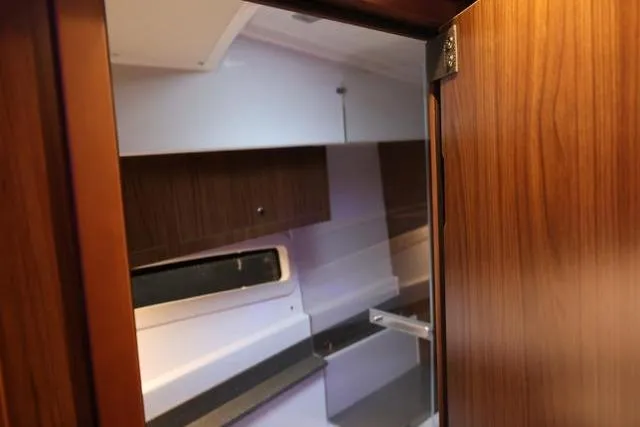  Yacht Photos Pics Interior view of 2021 Four Winns V355 Coupe, showcasing wooden cabinetry and modern design.