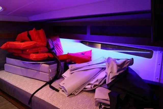  Yacht Photos Pics Interior of 2021 Four Winns V355 Coupe with life jackets and cushions on a bench.