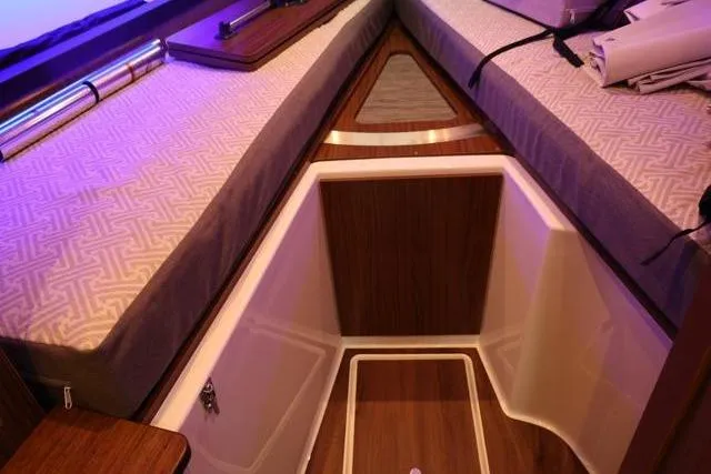  Yacht Photos Pics Interior cabin of 2021 Four Winns V355 Coupe with wood accents and cushioned seating.
