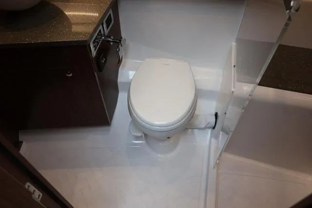  Yacht Photos Pics 2021 Four Winns V355 Coupe bathroom with modern toilet and sleek design.