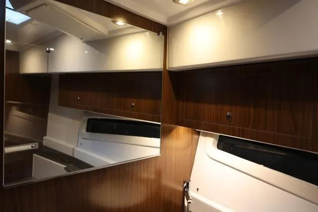  Yacht Photos Pics Interior of 2021 Four Winns V355 Coupe with wood paneling and modern lighting.