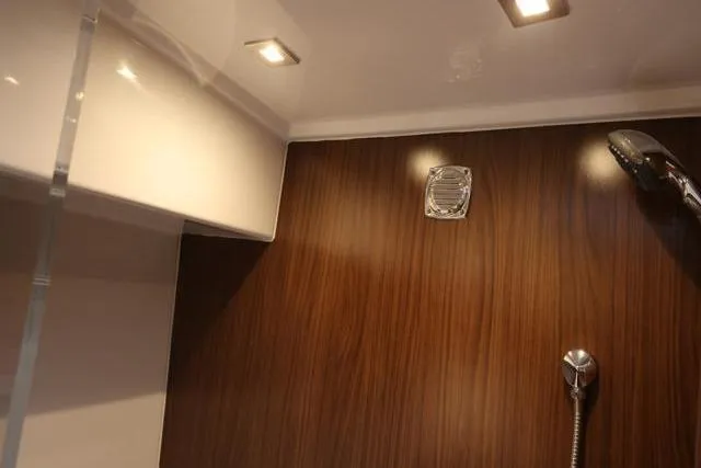  Yacht Photos Pics Interior of 2021 Four Winns V355 Coupe, featuring modern shower with wood paneling.