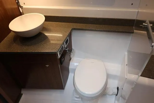  Yacht Photos Pics 2021 Four Winns V355 Coupe bathroom with modern sink and toilet.