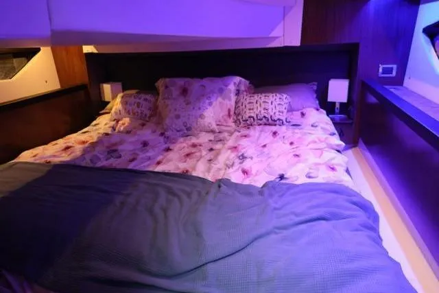  Yacht Photos Pics Luxurious bedroom interior of 2021 Four Winns V355 Coupe yacht with cozy bedding.
