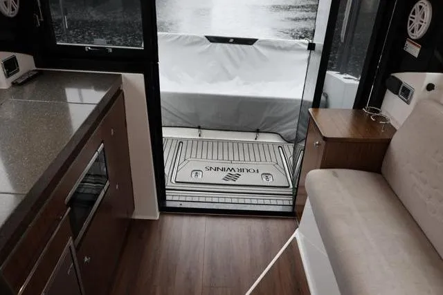  Yacht Photos Pics Interior of 2021 Four Winns V355 Coupe, featuring modern kitchen and seating area.