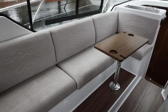  Yacht Photos Pics 2021 Four Winns V355 Coupe interior with beige seating and wooden table.