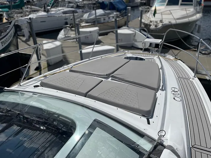  Yacht Photos Pics 2021 Four Winns Vista 355 Coupe with sun pads docked at a marina.