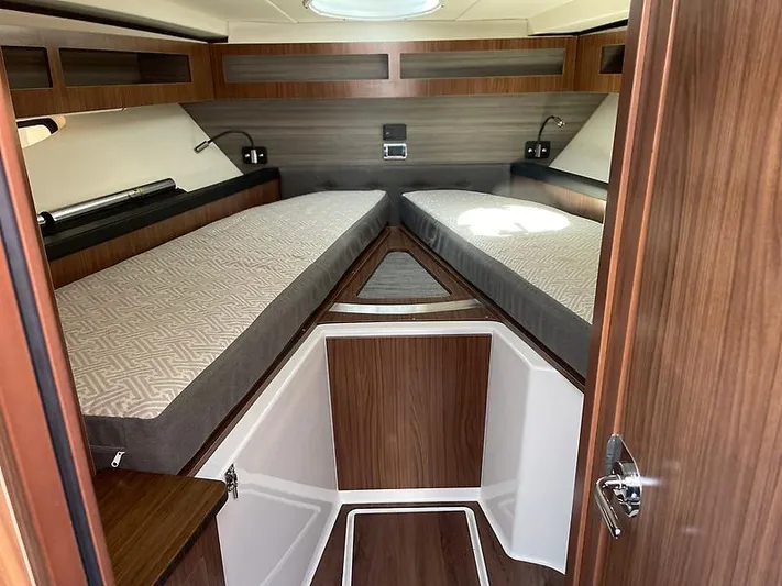  Yacht Photos Pics 2021 Four Winns Vista 355 Coupe cabin interior with twin beds and wood finish.