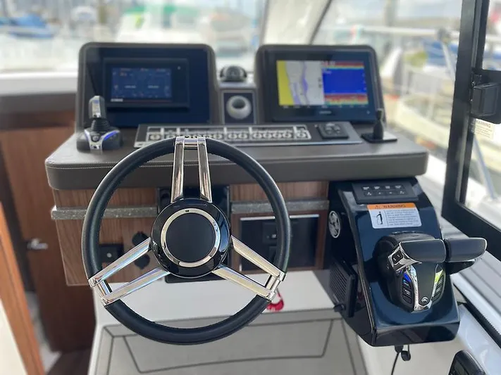  Yacht Photos Pics 2021 Four Winns Vista 355 Coupe helm with modern controls and navigation displays.