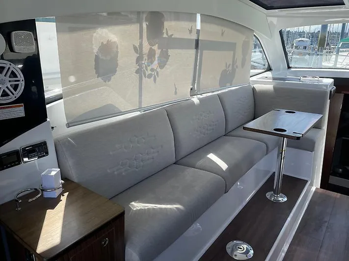 Yacht Photos Pics Interior of 2021 Four Winns Vista 355 Coupe with elegant seating and table.