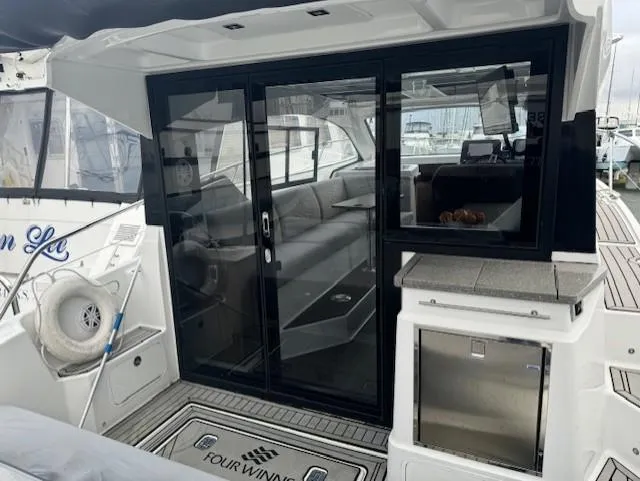  Yacht Photos Pics 2021 Four Winns Vista 355 Coupe yacht with sleek interior and glass doors.