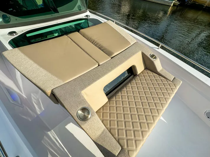  Yacht Photos Pics Luxurious sunbed on 2024 Axopar 37XC CROSS CABIN, featuring beige cushions and diamond-patterned upholstery.