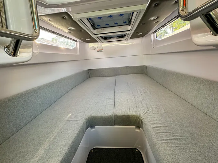  Yacht Photos Pics 2024 Axopar 37XC CROSS CABIN interior with spacious gray seating and overhead skylight.