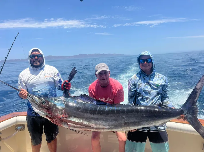  Yacht Photos Pics Three people holding a large fish on a 1988 Ocean Yachts 38 Super Sport boat.