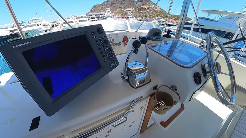  Yacht Photos Pics Helm of 1988 Ocean Yachts 38 Super Sport with navigation equipment and steering wheel.