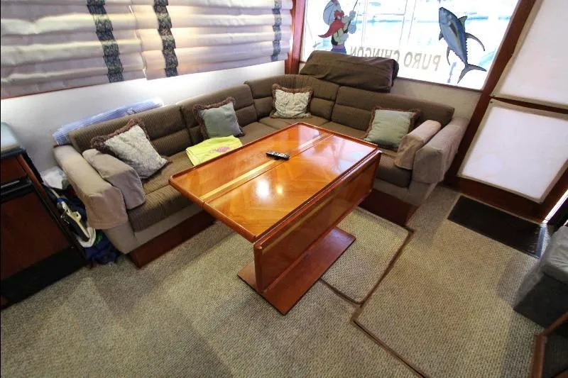  Yacht Photos Pics Interior of 1988 Ocean Yachts 38 Super Sport with cozy seating and wooden table.