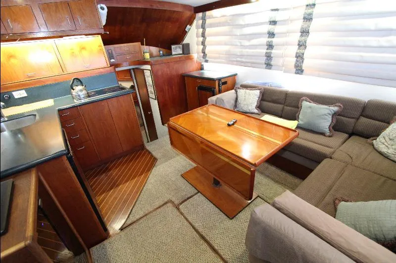  Yacht Photos Pics Interior of 1988 Ocean Yachts 38 Super Sport with wood cabinetry and cozy seating area.