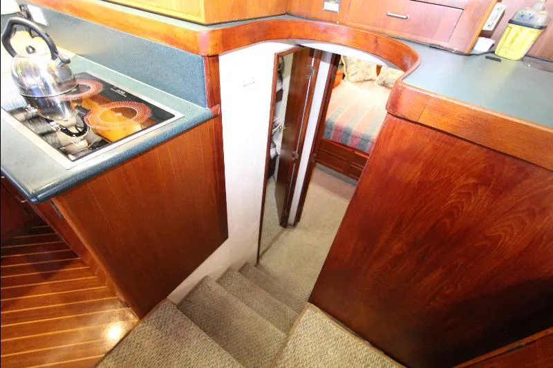  Yacht Photos Pics Interior of 1988 Ocean Yachts 38 Super Sport, featuring wooden cabinetry and compact kitchen area.