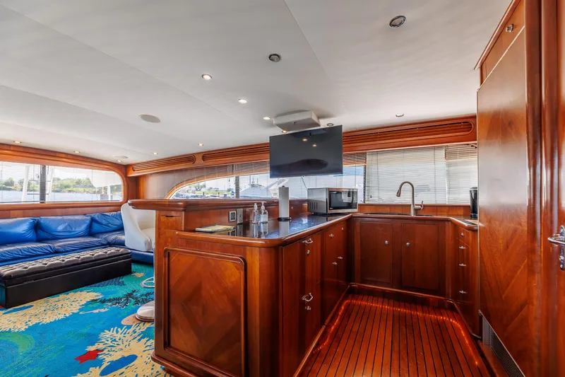 Stress Relief Yacht Photos Pics Luxurious 2003 Tiffany Enclosed Bridge Sport Fish yacht interior with wood finishes and vibrant carpet.