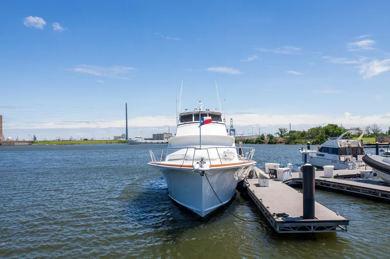 Stress Relief Yacht Photos Pics 2003 Tiffany Enclosed Bridge Sport Fish yacht docked in a marina under clear blue skies.
