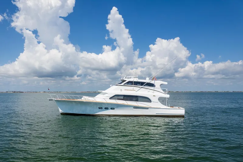 Stress Relief Yacht Photos Pics 2003 Tiffany Enclosed Bridge Sportfish yacht on calm sea under blue sky.