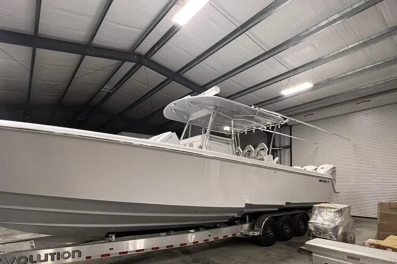 Dig It Yacht Photos Pics 2022 Contender 39 ST boat in a warehouse on a trailer.