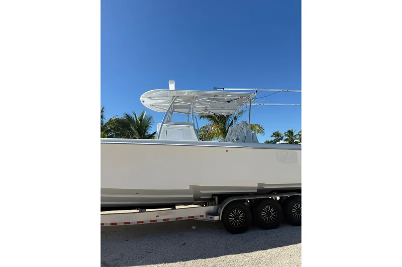 Dig It Yacht Photos Pics 2022 Contender 39 ST boat on trailer under clear blue sky.