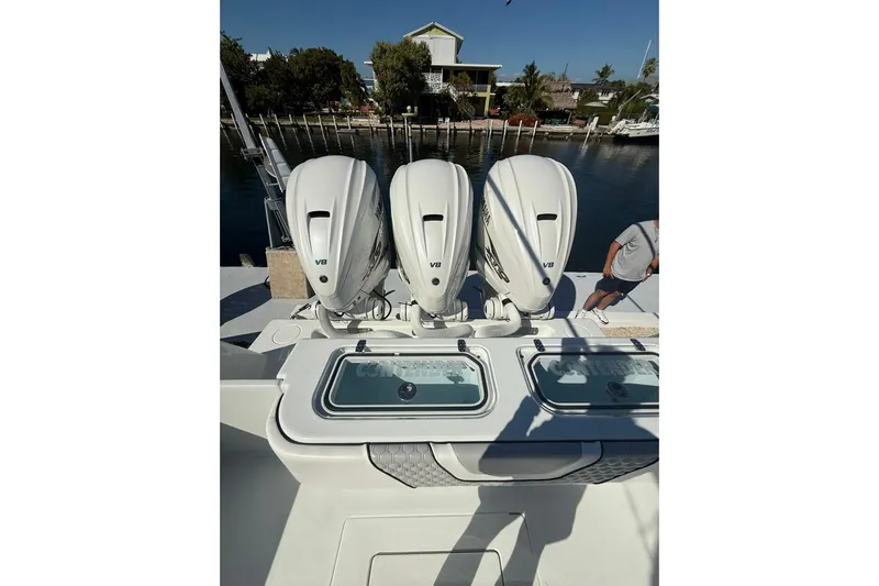 Dig It Yacht Photos Pics 2022 Contender 39 ST boat with triple V8 engines docked by the water.