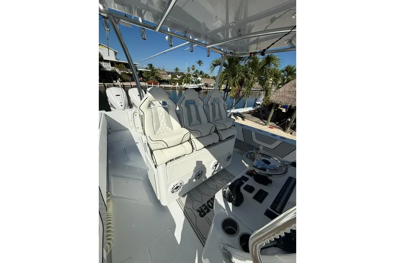 Dig It Yacht Photos Pics 2022 Contender 39 ST boat interior with luxury seating and steering console.