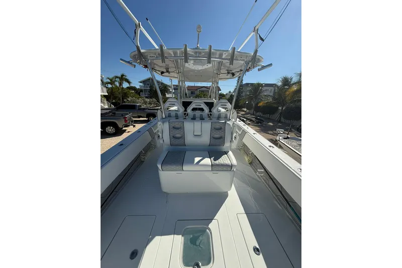 Dig It Yacht Photos Pics 2022 Contender 39 ST boat interior with seating and helm, under clear blue sky.