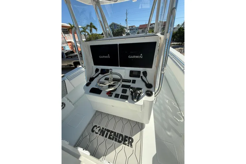 Dig It Yacht Photos Pics 2022 Contender 39 ST boat console with Garmin displays and steering wheel.