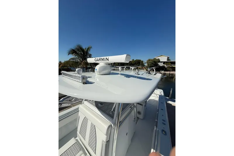 Dig It Yacht Photos Pics 2022 Contender 39 ST boat with Garmin radar, docked under clear blue sky.