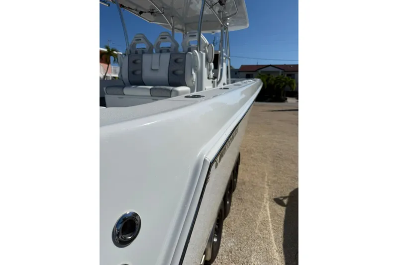 Dig It Yacht Photos Pics 2022 Contender 39 ST boat, sleek design, white exterior, comfortable seating, sunny day.