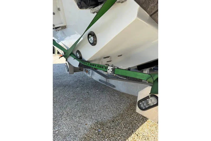 Dig It Yacht Photos Pics 2022 Contender 39 ST boat secured with green straps on a trailer.