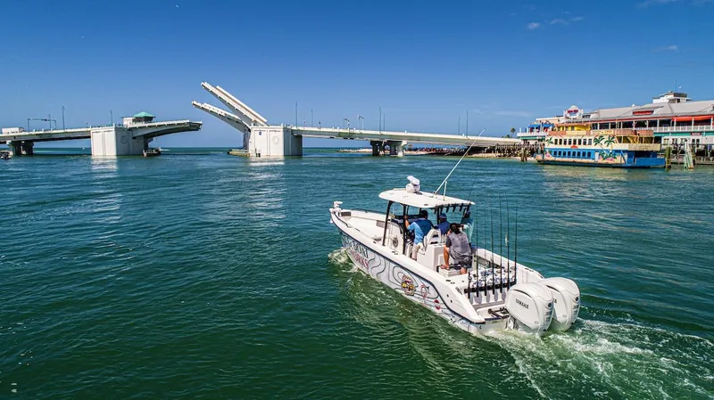  Yacht Photos Pics 2023 CG Boat Works 35 M-Series cruising near an open drawbridge on a sunny day.