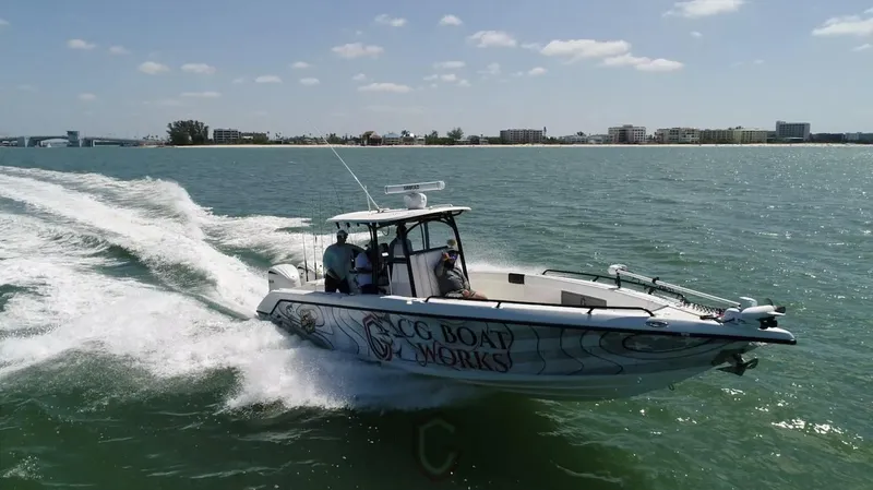  Yacht Photos Pics 2023 CG Boat Works 35 M-Series cruising on open water near coastline.