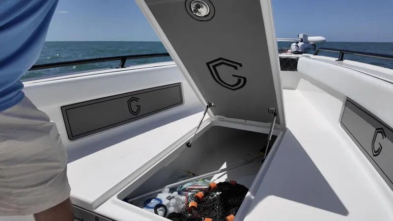  Yacht Photos Pics 2023 CG Boat Works 35 M-Series open storage compartment on deck, ocean in background.