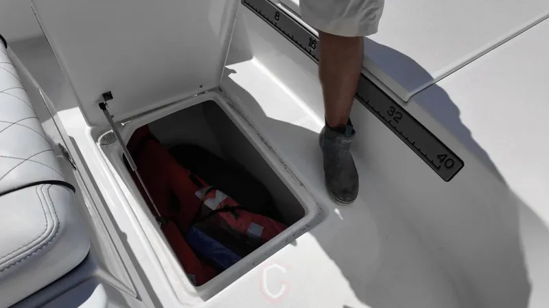  Yacht Photos Pics Open storage compartment on 2023 CG Boat Works 35 M-Series, featuring a measuring scale.
