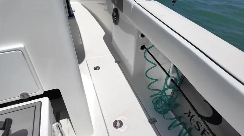  Yacht Photos Pics 2023 CG Boat Works 35 M-Series deck with coiled hose and storage compartments.