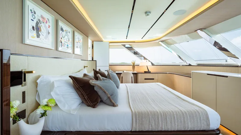 Midnight Saga Yacht Photos Pics Luxurious bedroom interior on 2023 Moonen 110 yacht, featuring elegant decor and large windows.