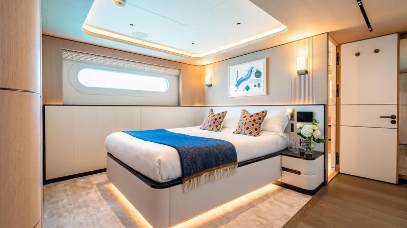 Midnight Saga Yacht Photos Pics Luxurious bedroom interior of 2023 Moonen 110 yacht, featuring modern design and elegant decor.