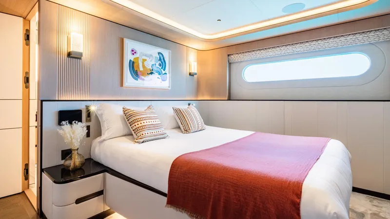 Midnight Saga Yacht Photos Pics Luxurious bedroom interior on 2023 Moonen 110 yacht, featuring modern decor and elegant lighting.