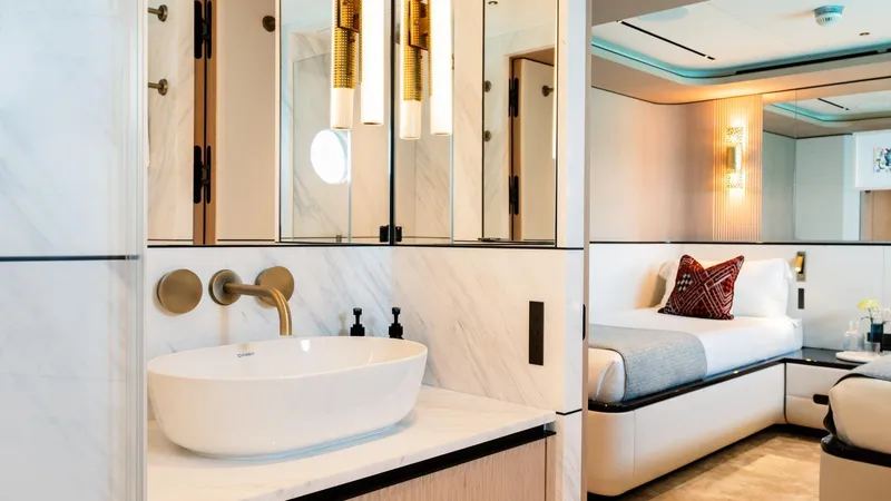 Midnight Saga Yacht Photos Pics Luxurious interior of 2023 Moonen 110 yacht featuring modern bathroom and elegant bedroom design.