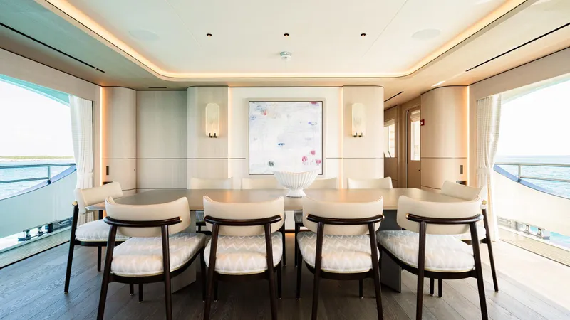Midnight Saga Yacht Photos Pics Luxurious dining area on 2023 Moonen 110 yacht with elegant seating and ocean views.