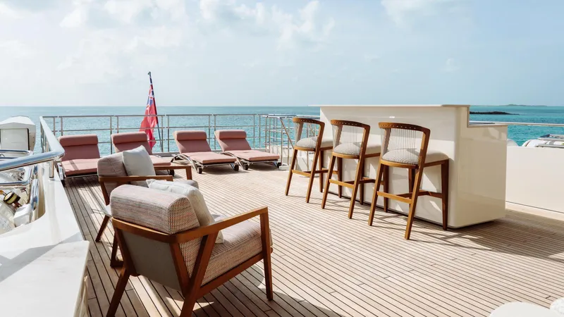 Midnight Saga Yacht Photos Pics Luxurious deck of 2023 Moonen 110 yacht with bar and lounge chairs.