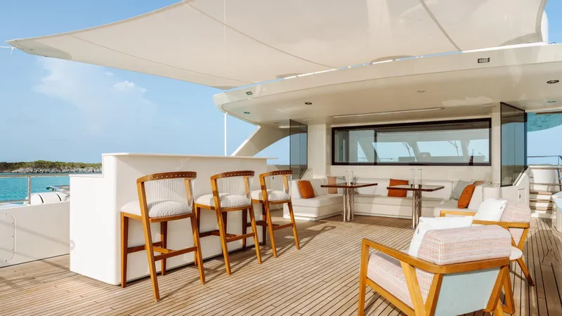 Midnight Saga Yacht Photos Pics Luxurious 2023 Moonen 110 yacht deck with elegant seating and bar area.