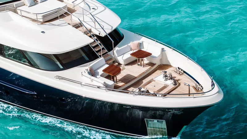 Midnight Saga Yacht Photos Pics Luxurious 2023 Moonen 110 yacht cruising on turquoise waters, featuring elegant deck seating.